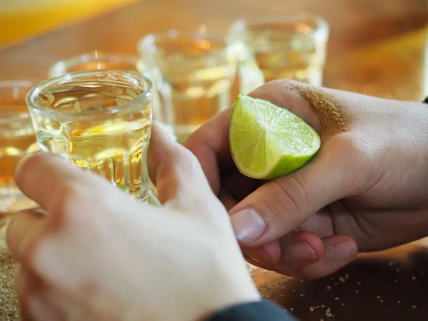 A person savoring tequila, appreciating its aroma and flavor